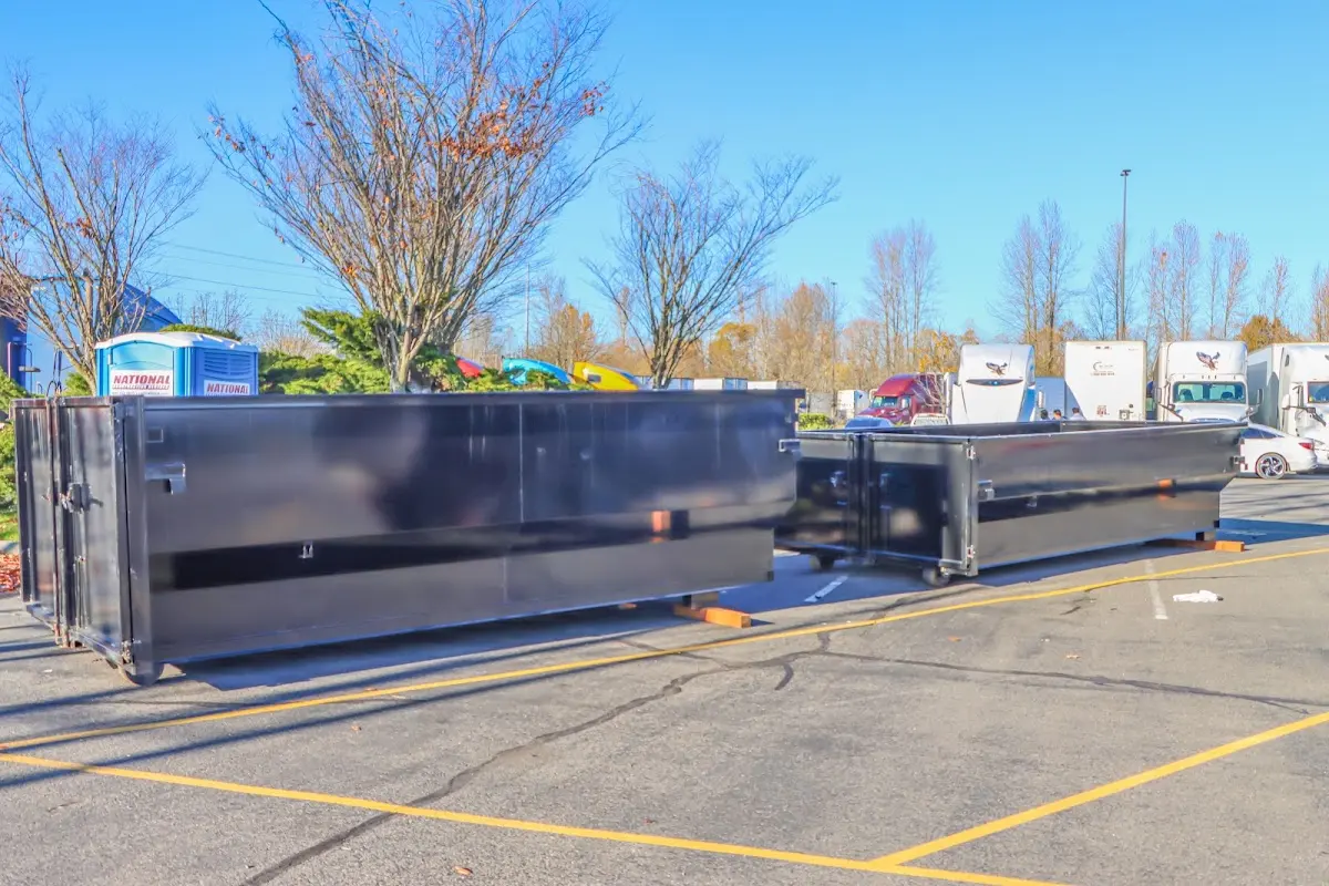 Professional dumpster rental service with roll-off container on residential driveway in Vineland